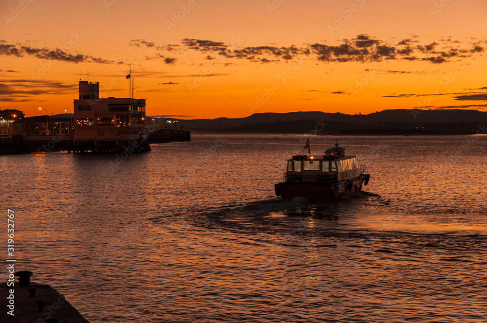 Reginas boat at Santander harbor during the sunrise