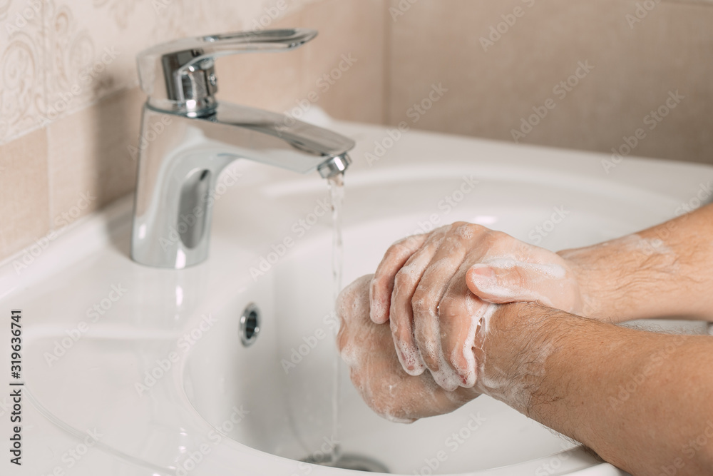 Washing hands under the water tap or faucet without soap. Hygiene concept detail. Beautiful hand and water stream in bathroom. Washing hands under the water tap or faucet without soap. Hygiene concept detail. Beautiful hand and water stream in bathroom.