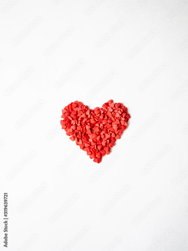 Red sugar sprinkles heart. Sugar sprinkle hearts, decoration for cake and bakery, symbol of love on valentines day on white background. Top view
