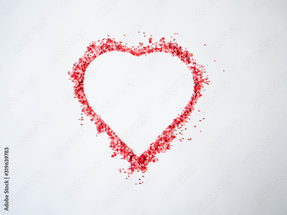 Colored sugar sprinkles heart, Sugar sprinkle dots and hearts, decoration for cake and bakery, heart shaped symbol of love on valentines day. Top view
