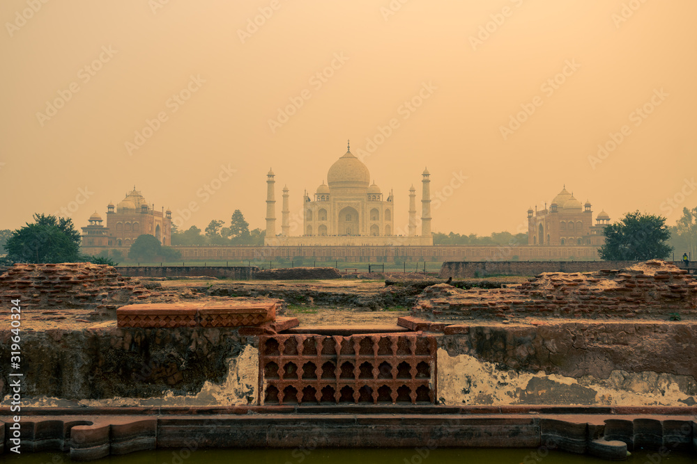 Wide shot of the backside of the Taj Mahal in Agra, India on overcast day with smog