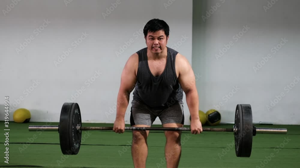 young man lifting weights barbell in gym young man lifting weights barbell in gym