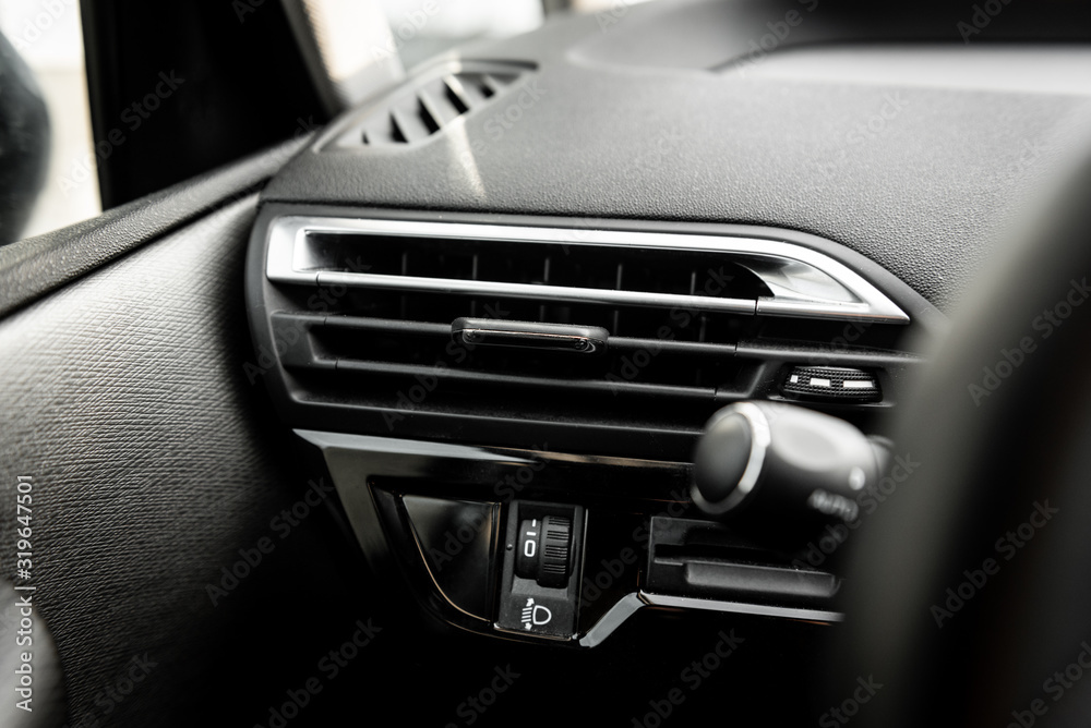 Car air conditioning panel on the luxury car console. Car climate control.