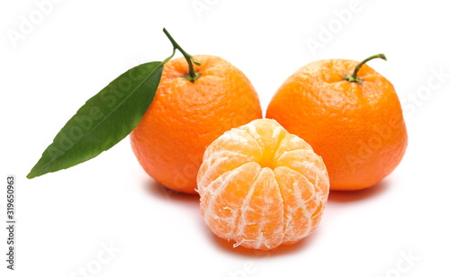 Mandarins and peeled pieces with leaf isolated on white background