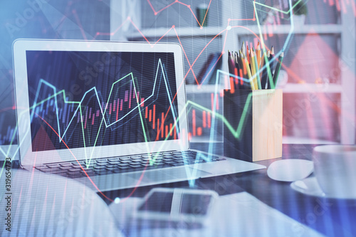 Stock market graph on background with desk and personal computer. Multi exposure. Concept of financial analysis. © peshkova