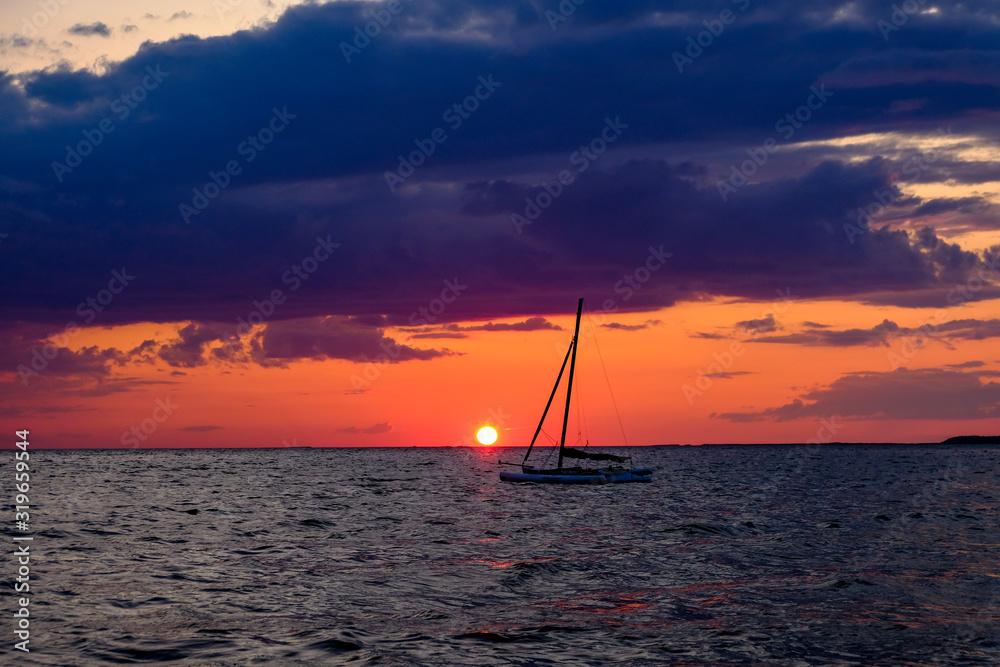 Fototapeta premium Sunset far beyond horizon after a beautiful summer day on Cape Cod`s popular and endless beaches (Massachusetts, USA).
