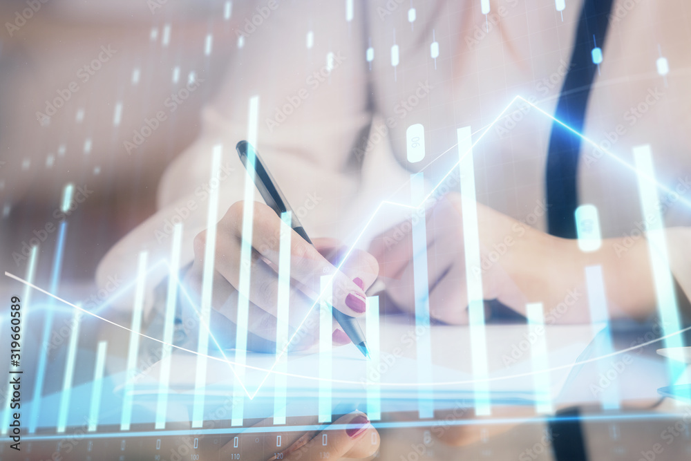 Double exposure of hands making notes with forex chart huds. Stock market concept. Double exposure of hands making notes with forex chart huds. Stock market concept.