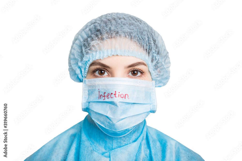 Portrait of young woman wearing medical uniform and mask with infection text isolated on white background. Protect your health. Coronavirus concept Portrait of young woman wearing medical uniform and mask with infection text isolated on white background. Protect your health. Coronavirus concept