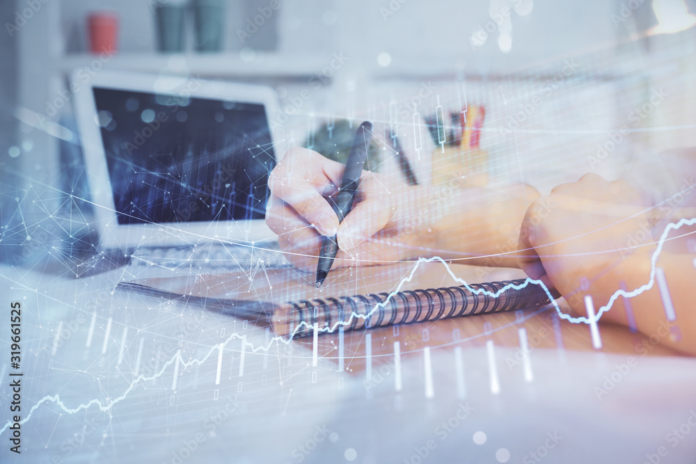 Financial graph displayed on woman's hand taking notes background. Concept of research. Double exposure Financial graph displayed on woman's hand taking notes background. Concept of research. Double exposure