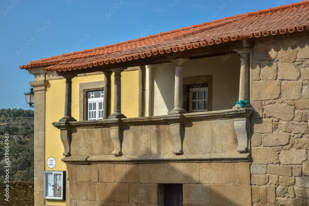 Detailed view of a house on medieval village inside fortress castle of Castelo Mendo, plaza and medieval buildings