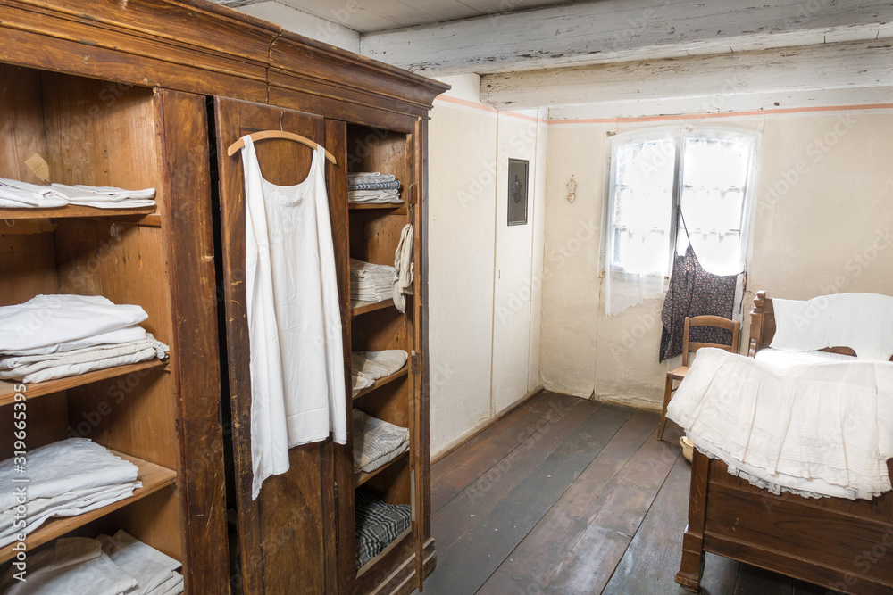 Antiquated bedroom with linen clothing