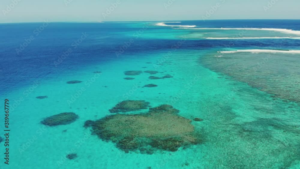 Panoramic day time wide tilting shot of blue water Ocean with Corals against clear sky, coastal scene Panoramic day time wide tilting shot of blue water Ocean with Corals against clear sky, coastal scene