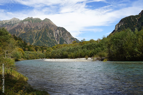 Beautiful crystal clear water river landscape with mountain background in Japan Alps Kamikochi  Nagano