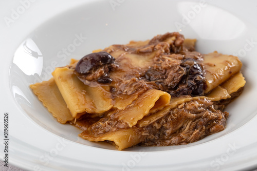 Traditional italian pasta. Homemade freshness pappardelle. Pasta with with a rabbit. Homemade delicious italian traditional pasta on wooden table for dinner. italian cuisine.