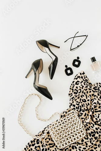 Modern fashion female clothes and accessories on white background. Flatlay, top view.