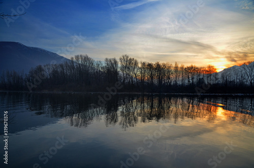 Sunset over an Alpine Lake with Mirror Image and Mountain in Switzerland.