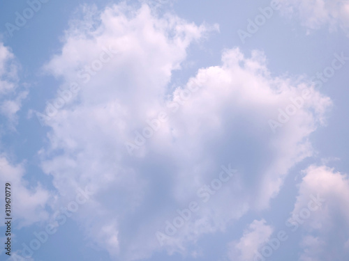 puffy fluffy clouds heart shape evening  light sky horizontal in spring evening  abstract nature background.