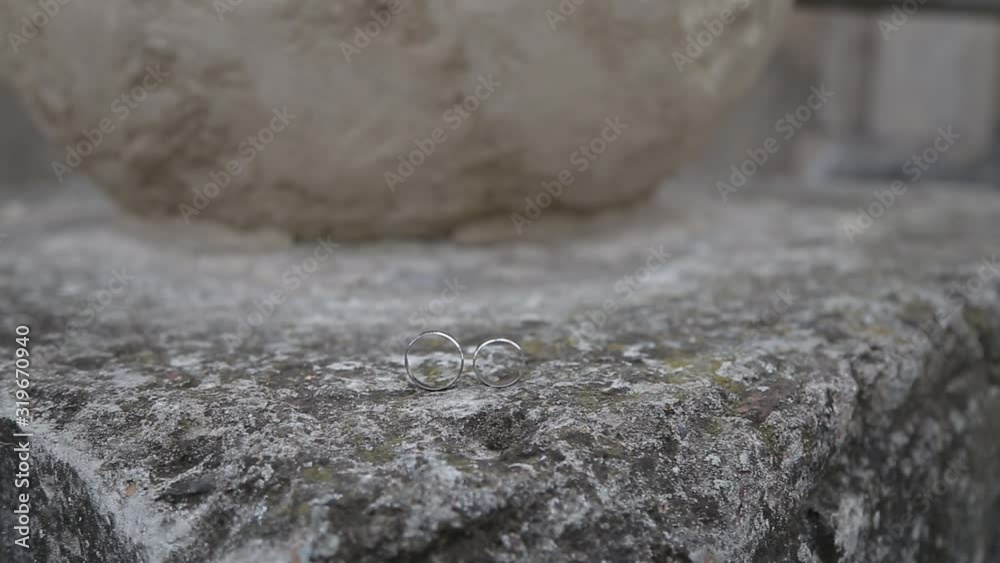 Gold ring lie on the stone surface in sunny day Gold ring lie on the stone surface in sunny day