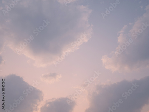 puffy fluffy clouds sun light in spring evening with blue sky horizontal , abstract nature background
