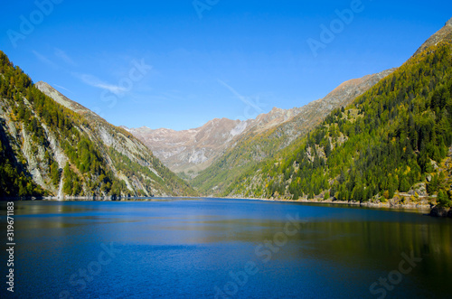 Sambuco Water Dam with Reflection and Mountain with Blue Sky in Ticino, Switzerland.