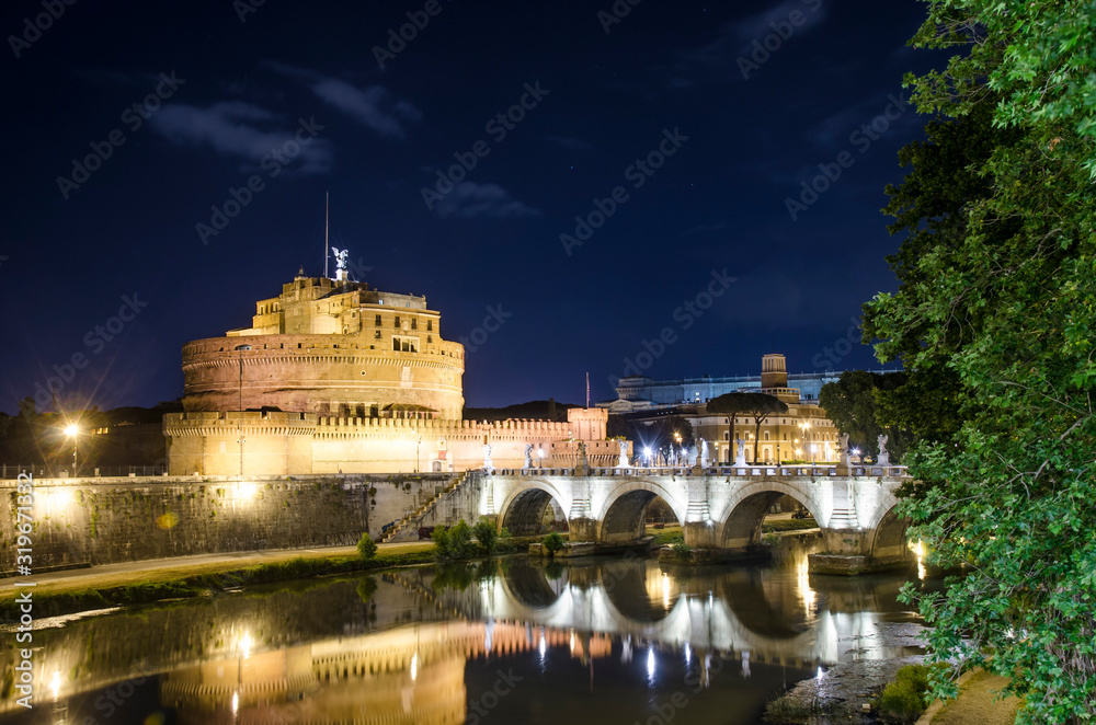 View of Castel Sant Angel (Castle of Holy Angel) in Rome, Italy. Panoramic view of Castel Angelo illuminated with the ancient bridge at night. View of Castel Sant Angel (Castle of Holy Angel) in Rome, Italy. Panoramic view of Castel Angelo illuminated with the ancient bridge at night.