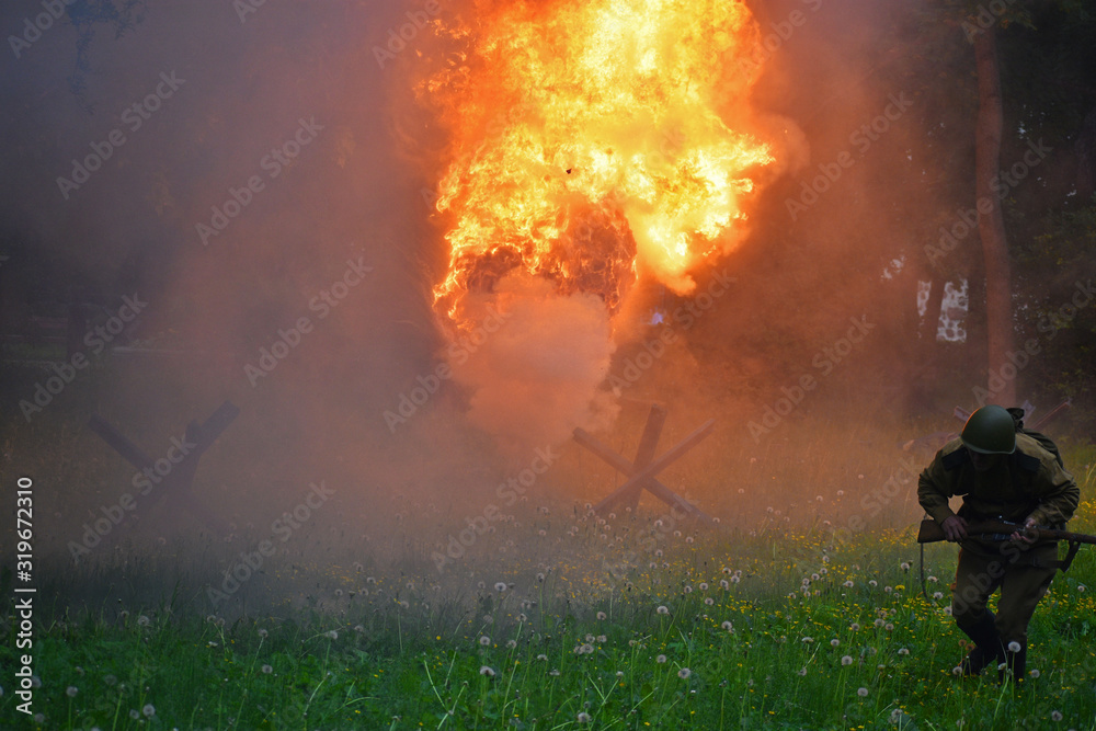 Fototapeta premium Running soldier on the battlefield and the fire of explosion