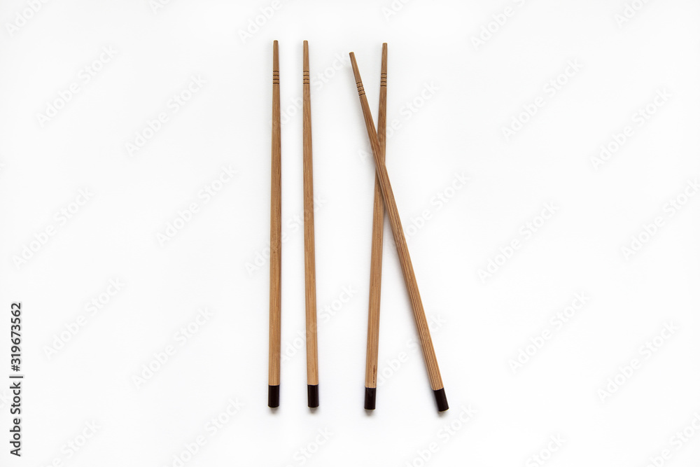 Wooden pairs of chopsticks on white background. cooking culture in Asian countries. Wooden pairs of chopsticks on white background. cooking culture in Asian countries.