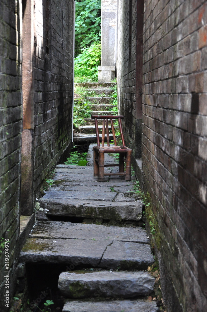Obraz premium bamboo chair in a village alley 
