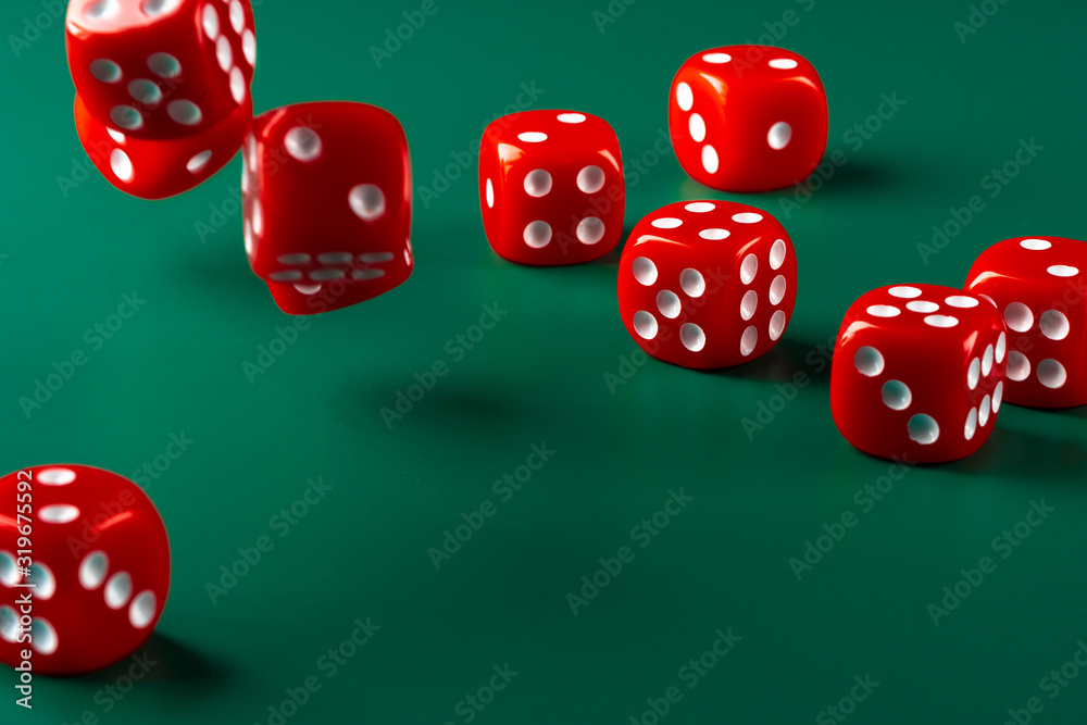 Red dice on green background close up Red dice on green background close up