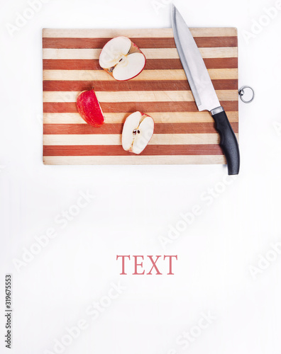 board with a knife and chopped apples