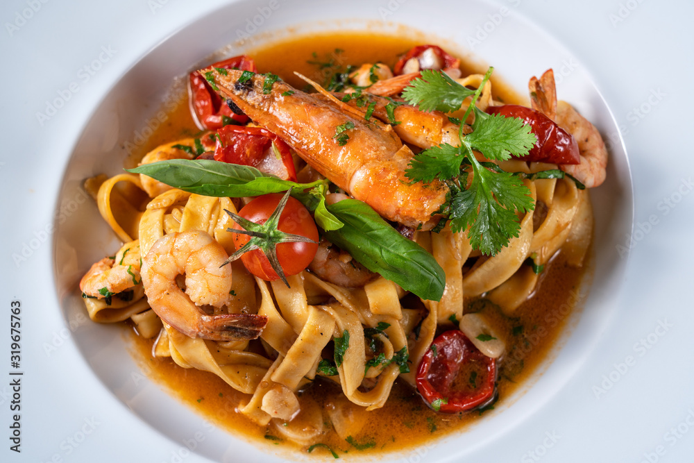 Italian pasta dish with shrimp stewed in sauce. Close from above.