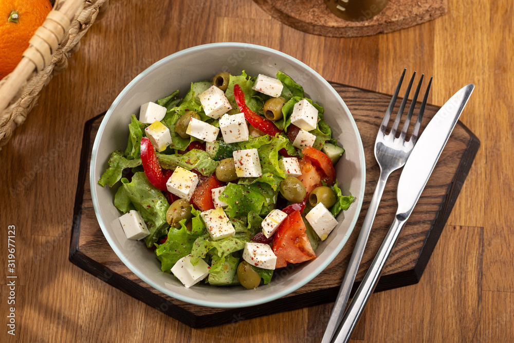 Delicious fresh salad. Greek salad with feta cheese, organic olives, juicy tomatoes, red pepper, red onion, cucumber and lettuce. Greek salad with fresh vegetables. Close up view on Salad. Healthy, di Delicious fresh salad. Greek salad with feta cheese, organic olives, juicy tomatoes, red pepper, red onion, cucumber and lettuce. Greek salad with fresh vegetables. Close up view on Salad. Healthy, di
