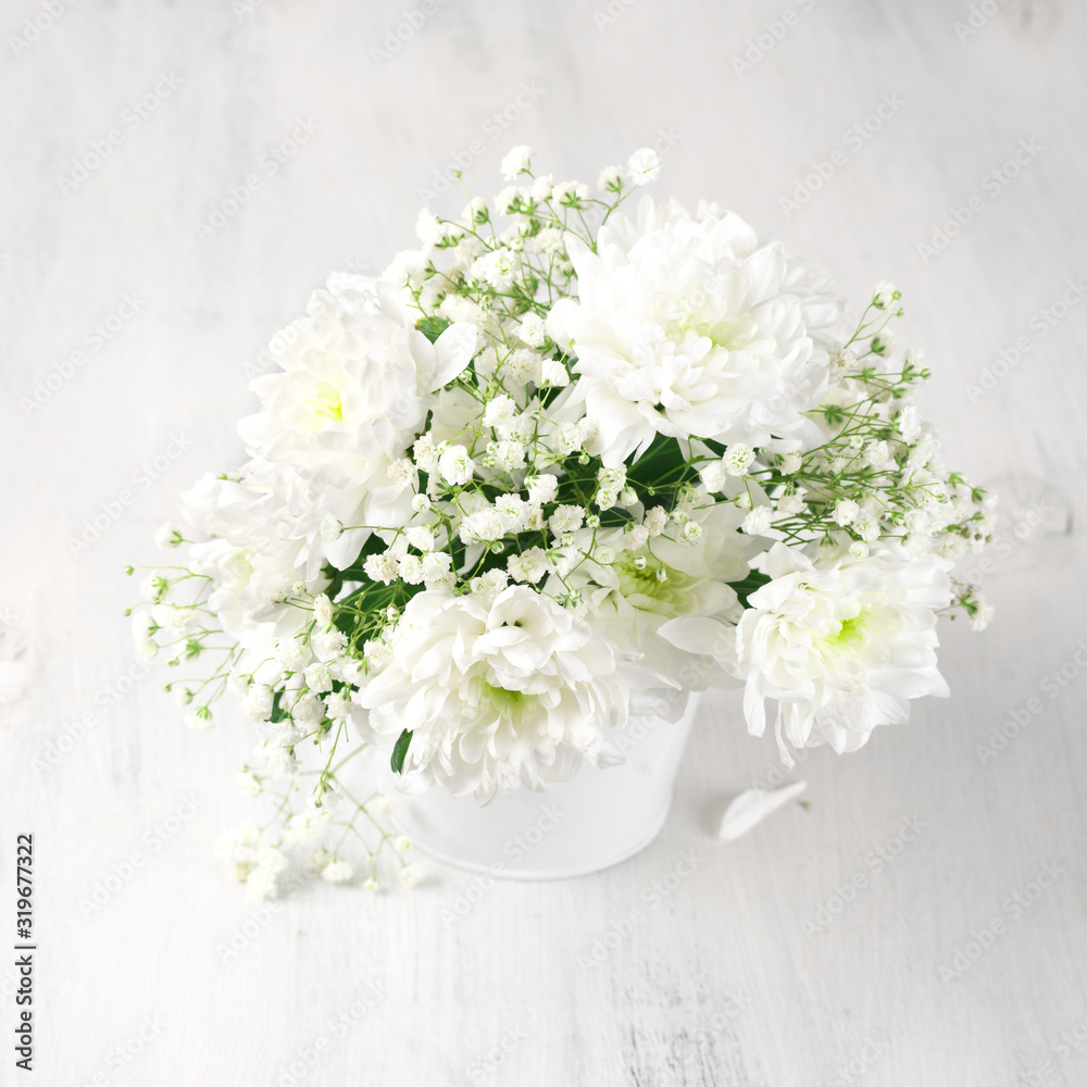 White flowers bouquet in bucket