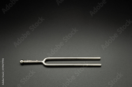 A tuning fork 440 Hz on a black background photo