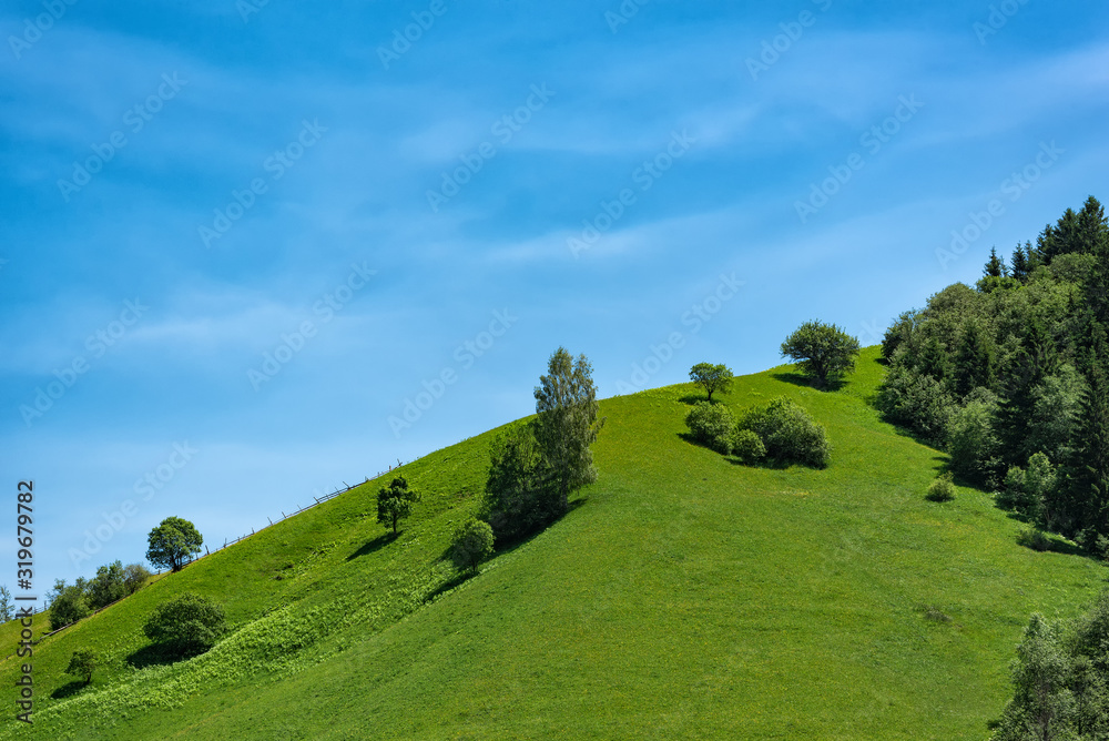 Green hill on blue sky background. Ecotourism recreation, countryside