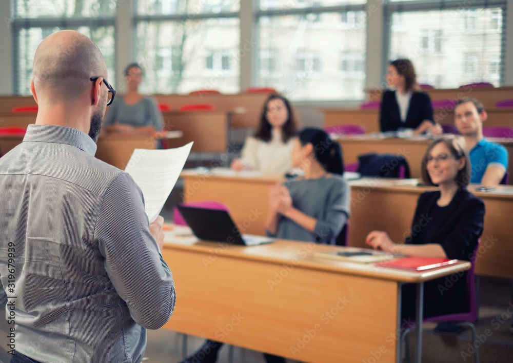Lecturer and multinational group of students in an auditorium Lecturer and multinational group of students in an auditorium