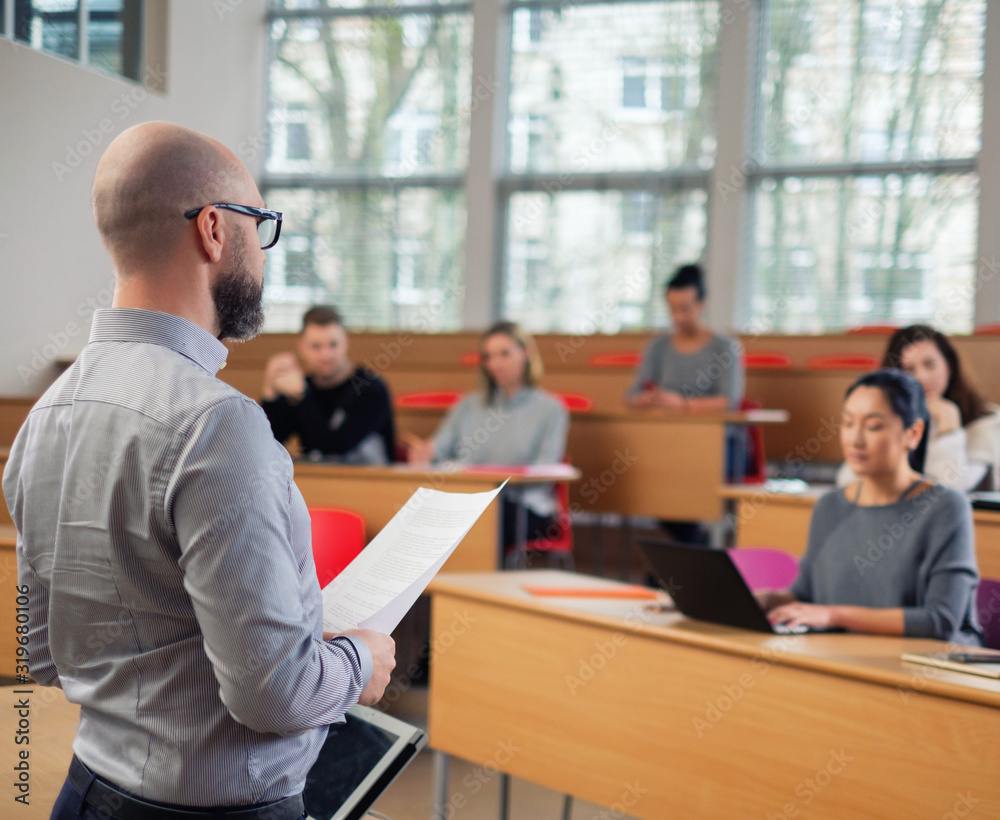 Lecturer and multinational group of students in an auditorium Lecturer and multinational group of students in an auditorium