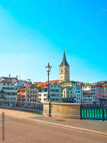 Zurich city center and Limmat quay in summer with St Peter clock tower in summertime, Switzerland