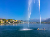 Fountain on Alpine Lake Lugano and City in Switzerland.