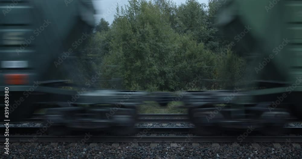 Freight train boxcar wagons high speed passing on railroad