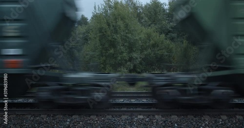 Freight train boxcar wagons high speed passing on railroad
