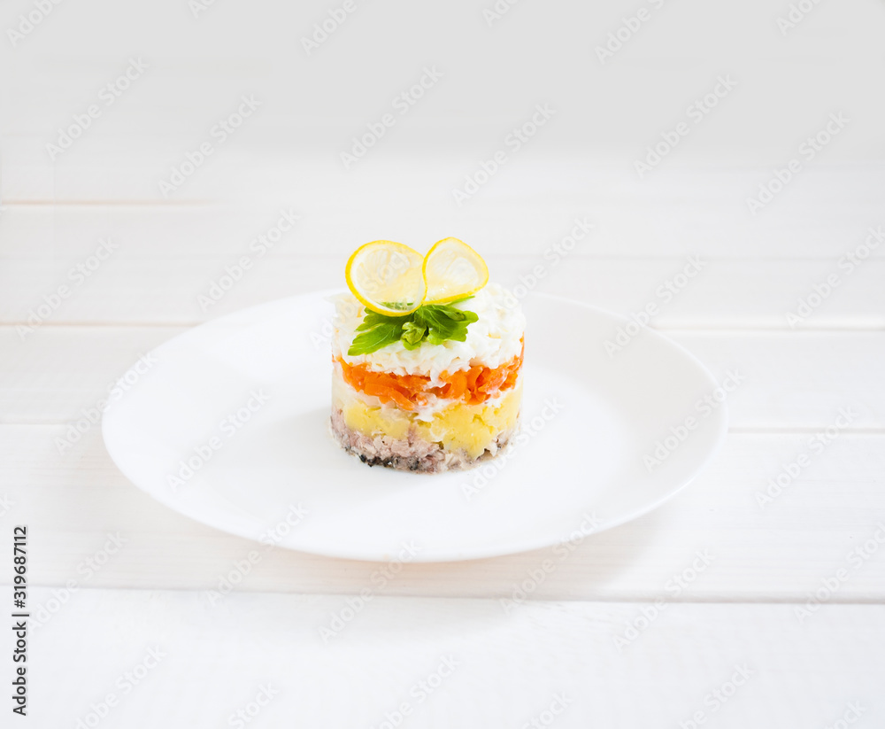 mimosa salad in layers on a wooden table mimosa salad in layers on a wooden table