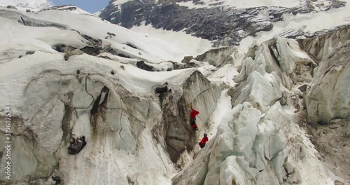 Himalayan mountaineers at Himalaya climbing peaks with high experience & high risk. Professional mountaineers at Himalayas. Ice axe use, pittons use by professional mountaineers. photo