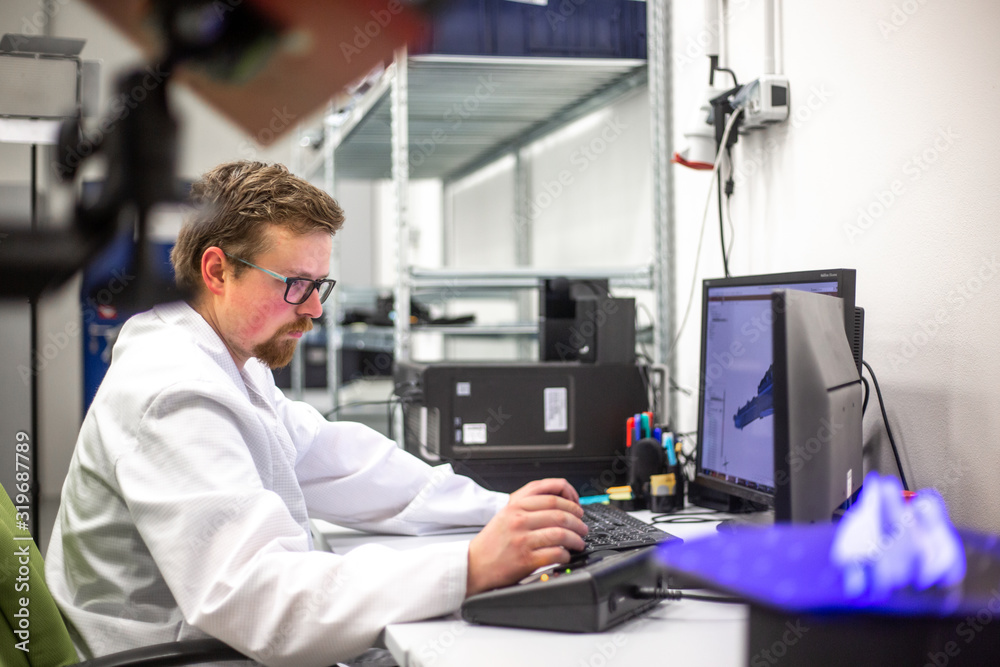 Quality metrologist scanning some moldings by professional optical 3D scanner with a turntable, automotive concept