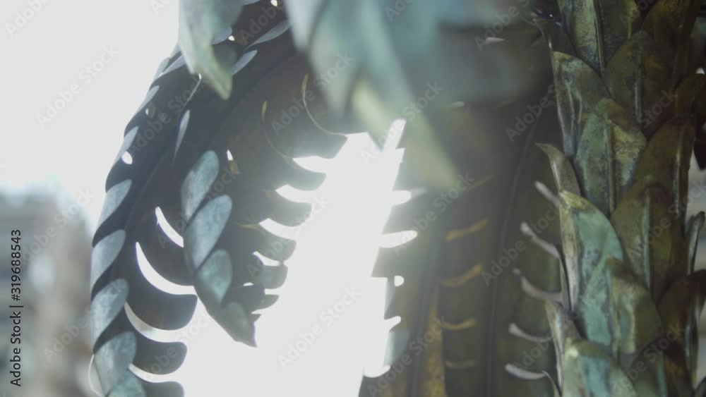 Slow motion close up of decorative gold palm tree