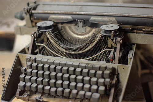 Old, antique typewriter close-up in the dust.