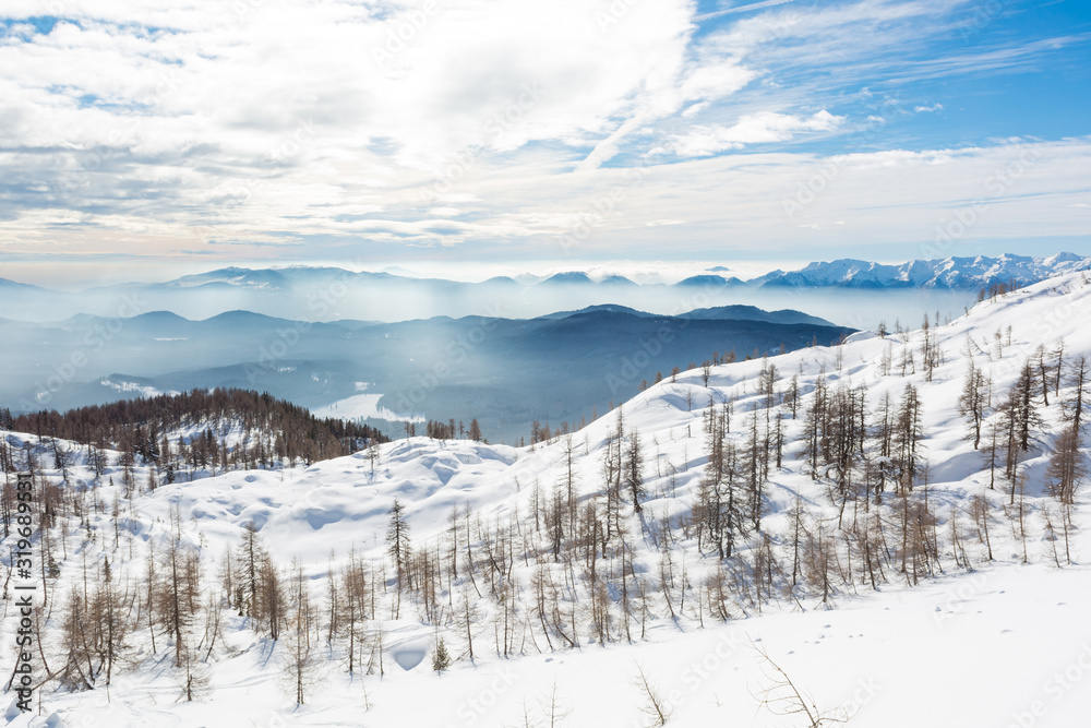 Spectacular winter mountain panorama with snow covered slopes.