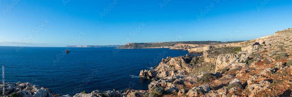 Beautiful view of blue mediterranean sea and rocky shore with cliffs at sunny winter day in Malta