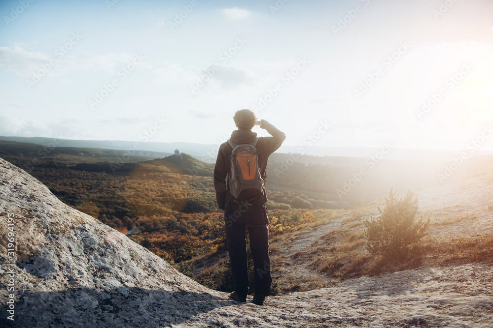 A traveler with a backpack looks at the upcoming path