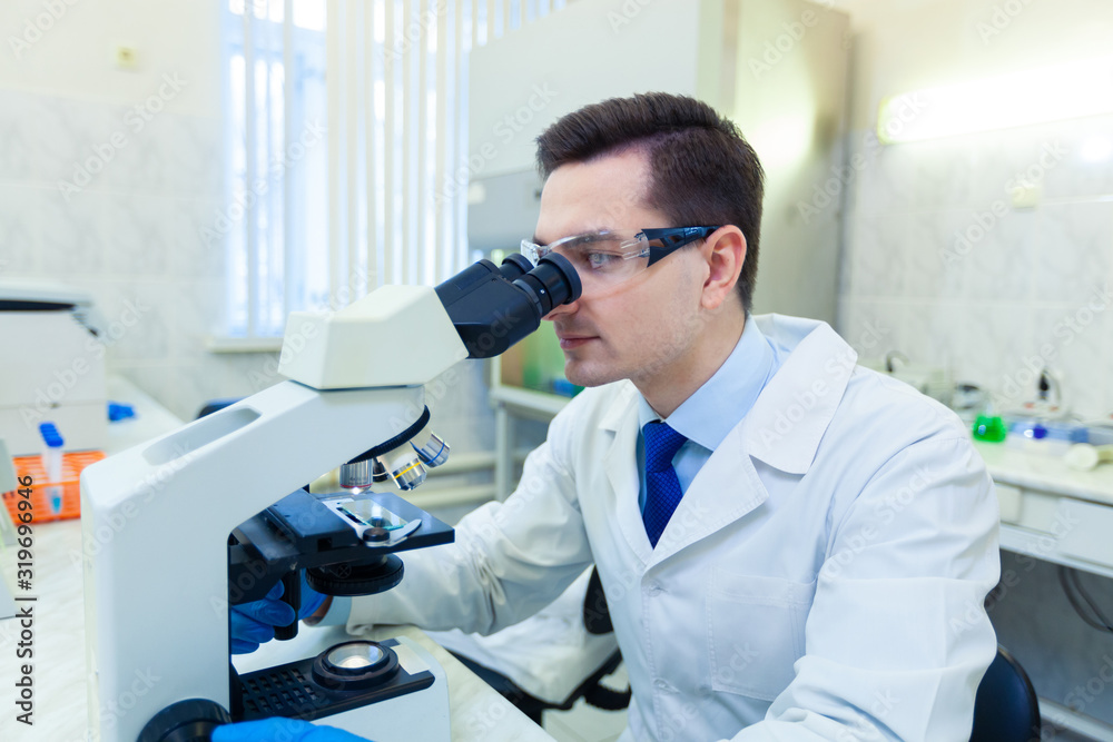Scientist studies properties and benefits of omega 3 fatty acids using microscope and laboratory equipment in a medical laboratory